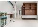 Light-filled hallway with contemporary built-in shelves at 2661 Via Tuscany, Winter Park, FL 32789