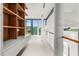 Modern hallway with built-in shelving and large windows at 2661 Via Tuscany, Winter Park, FL 32789