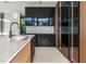 Modern kitchen with sleek, dark cabinetry and an island at 2661 Via Tuscany, Winter Park, FL 32789