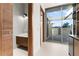 Stylish powder room with marble vanity and a view to a patio at 2661 Via Tuscany, Winter Park, FL 32789