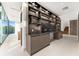 Modern wet bar with stylish cabinetry and a granite countertop at 2661 Via Tuscany, Winter Park, FL 32789