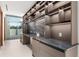 Contemporary wet bar boasting built-in shelving and granite countertops at 2661 Via Tuscany, Winter Park, FL 32789