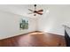 Spacious loft area with wood flooring and arched window at 4715 Capri Pl # 191, Orlando, FL 32811