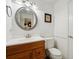 Simple bathroom with wood vanity and large mirror at 5417 Lake Margaret Dr # G, Orlando, FL 32812