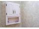 White bathroom cabinet with shelf; decorative items at 618 Gran Paseo Dr, Orlando, FL 32825