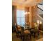 Dining room with glass table, taupe chairs, and geometric wallpaper at 8311 Lookout Pointe Dr, Windermere, FL 34786