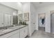 Double vanity bathroom with granite countertop and walk-in shower at 10156 Huntingnet Way, Leesburg, FL 34748