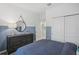 Bedroom with dresser and a bed, featuring a two-toned wall at 10156 Huntingnet Way, Leesburg, FL 34748