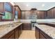 Kitchen with dark wood cabinets, granite countertops and stainless steel appliances at 10181 Armando Cir, Orlando, FL 32825