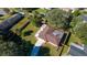 Aerial view of house with brown roof, yard, and trees at 1044 Mosshart Ln, Orlando, FL 32825