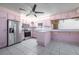 Updated kitchen with stainless steel appliances and pink cabinets at 1044 Mosshart Ln, Orlando, FL 32825