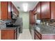 Galley-style kitchen with granite countertops and stainless steel appliances at 1090 Henry Balch Dr, Orlando, FL 32810