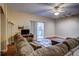 Living room with L-shaped sofa and sliding glass door to balcony at 132 Vista Verdi Cir # 100, Lake Mary, FL 32746