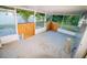 Screened porch with concrete flooring and a small stool at 1326 Dunbarton Ct, Kissimmee, FL 34758