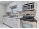 Modern kitchen featuring stainless steel appliances and white cabinets at 1410 Mount Vernon St, Orlando, FL 32803