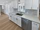 Modern white kitchen with quartz countertops and stainless steel appliances at 1417 Nottingham Dr, Winter Park, FL 32792