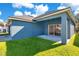 Home features a covered patio and grassy backyard at 14643 Tanja King Blvd, Orlando, FL 32828