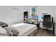Bright bedroom featuring a bed, workspace, and built-in shelving at 14643 Tanja King Blvd, Orlando, FL 32828