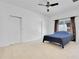 Spacious bedroom with carpeted floor, ceiling fan, and ample closet space at 14643 Tanja King Blvd, Orlando, FL 32828