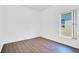 Simple bedroom with wood flooring and a large window at 14643 Tanja King Blvd, Orlando, FL 32828