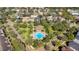 Aerial view of community pool with surrounding homes and landscaping at 14643 Tanja King Blvd, Orlando, FL 32828