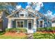 Beautiful blue house with white accents, landscaping, and a welcoming front porch at 14643 Tanja King Blvd, Orlando, FL 32828