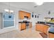 Kitchen with light wood cabinets, stainless steel appliances, and tile floor at 14643 Tanja King Blvd, Orlando, FL 32828