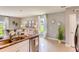 Kitchen island with granite countertop and double sink overlooking living room at 1625 Bull Hill Rd, Kissimmee, FL 34744