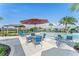 Poolside seating area with tables, chairs and umbrellas at 1633 Bull Hill Rd, Kissimmee, FL 34744