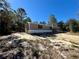 Manufactured home with a side view showcasing its light brown siding at 16770 Sw 60Th Pl, Ocala, FL 34481