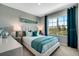 Bright bedroom with large window, comfortable bed, and teal accents at 1689 Three Bars Rd, Kissimmee, FL 34744