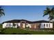 Single-story home with modern design, two-car garage, and landscaped yard at 17144 Phil C Peters Rd, Winter Garden, FL 34787