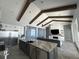 Open-concept kitchen with large island, stainless steel appliances, and wood beams at 17144 Phil C Peters Rd, Winter Garden, FL 34787