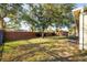 Spacious backyard with mature trees and brick wall at 2338 Darlin Cir, Orlando, FL 32820