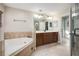 Spa-like bathroom with soaking tub, double vanity, and walk-in shower at 2338 Darlin Cir, Orlando, FL 32820