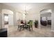 Dining room with glass table and four chairs, view of living room at 2338 Darlin Cir, Orlando, FL 32820