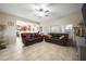Living room with leather couches, ceiling fan and view of kitchen at 2338 Darlin Cir, Orlando, FL 32820
