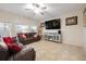 Living room with leather couches, large TV and ceiling fan at 2338 Darlin Cir, Orlando, FL 32820