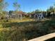 Large backyard with overgrown grass, swing set, and shed at 3481 Cornell Ter, Deltona, FL 32738