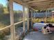Overgrown screened porch with concrete flooring at 3481 Cornell Ter, Deltona, FL 32738