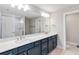 Elegant bathroom with double vanity, large mirror, and walk-in shower at 4067 Meandering Bay Dr, Apopka, FL 32712