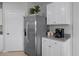 White shaker cabinets, stainless steel refrigerator, and gray countertops at 427 Taylor Groves Dr, Lake Wales, FL 33853