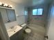 Clean bathroom with a bathtub and gray vanity at 4518 Watch Hill Rd, Orlando, FL 32808