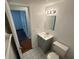 Small bathroom with gray vanity and toilet at 4518 Watch Hill Rd, Orlando, FL 32808