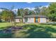 Charming ranch home with a teal door and well-manicured lawn at 595 Preston Rd, Longwood, FL 32750