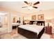 Spacious Primary bedroom with a king-size bed and mirrored closets at 6850 Spring Rain Dr, Orlando, FL 32819