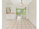 Kitchen with white cabinets and a view into the dining area at 8057 Laso Way, Orlando, FL 32822