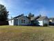 Newly built light blue house with a large green lawn at 8524 Se 160Th Pl, Summerfield, FL 34491