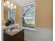 Updated bathroom with granite vanity and large window at 1054 Waterside Dr, Celebration, FL 34747