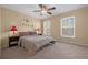 Comfortable main bedroom with a queen bed and window seating at 1054 Waterside Dr, Celebration, FL 34747